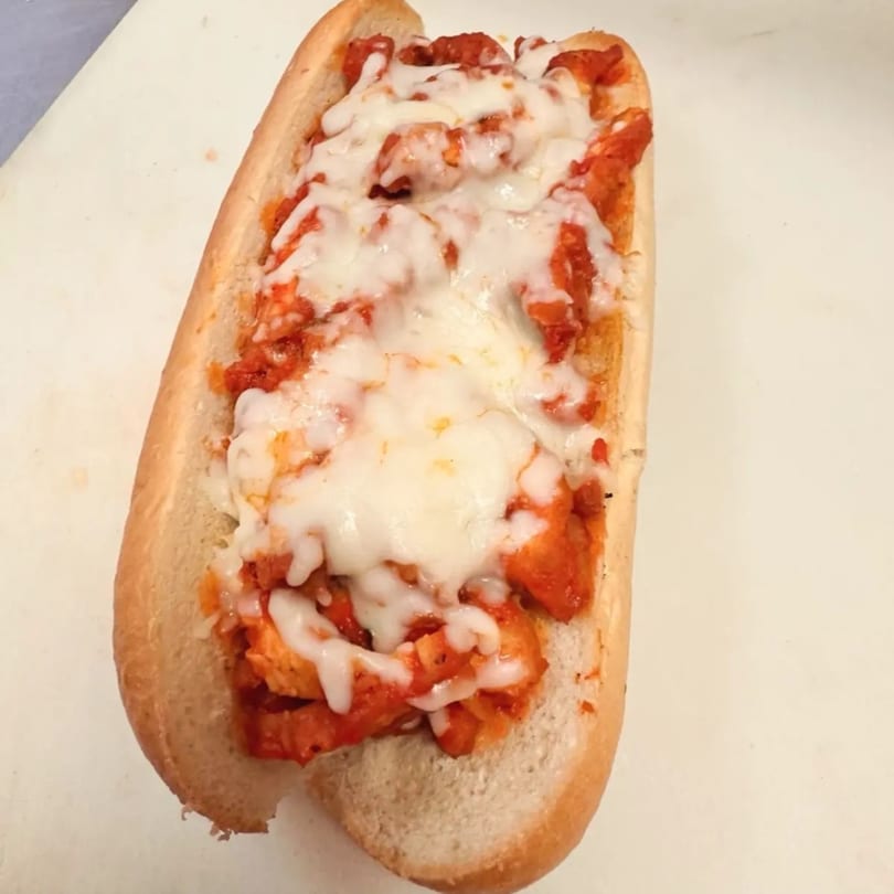 A chicken parmesan hero sandwich from A&J Italian Deli, with melted mozzarella and red sauce.